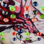 Abstract spray painted wine glass splash LED bottle display holder.