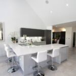 Large breakfast bar seating area on kitchen peninsula perfect for entertaining guest while cooking and prepping food.