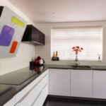 German engineered Hacker kitchen shown in pearl grey and polar white gloss with white cosmic and grey glitter quartz.