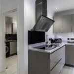 High end modern matt cashmere kitchen with matching utlity room units.